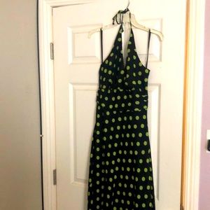 Dress Barn halter dress with big green polka dots on a black background.